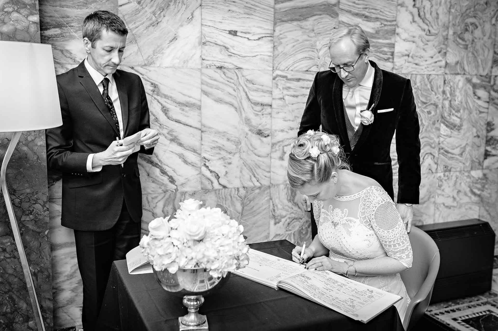 Bride Signing the Register at Fitzrovia Chapel Wedding